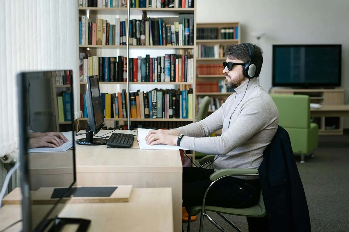 A blind student works at a computer
